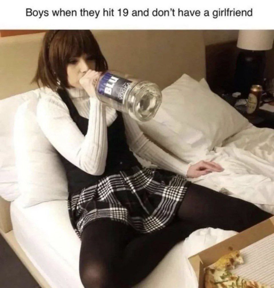 Boys when they hit 19 and don't have a girlfriend Парень в женской одежде пьёт водку Blu из горла на кровати, рядом с ним коробка пиццы, а на стене висит лампа