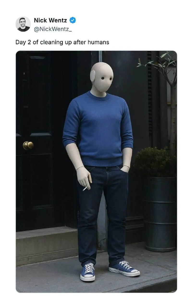 Day 2 of cleaning up after humans Робот в синем свитере и джинсах, курящий сигарету, стоит на улице