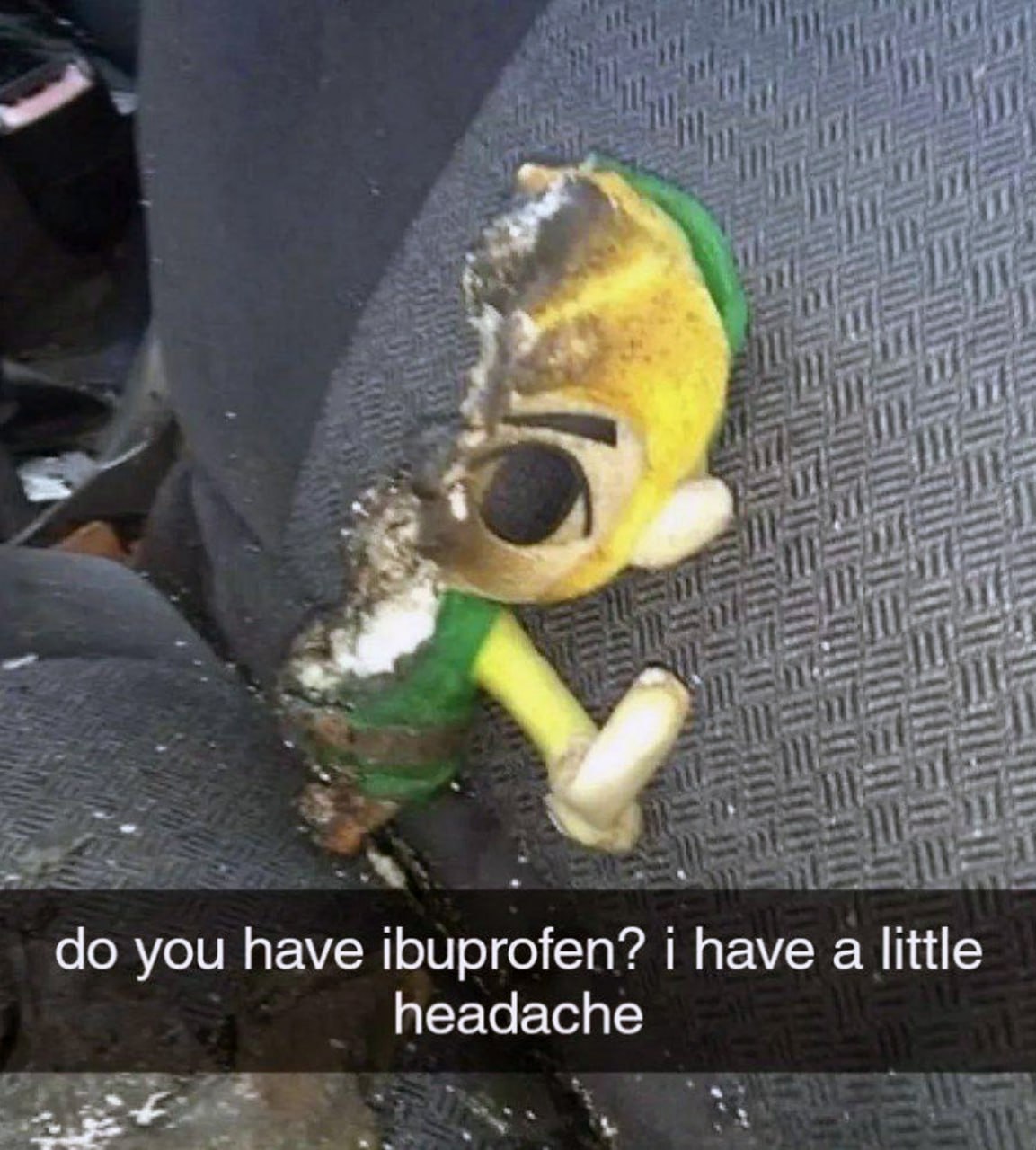 Do you have ibuprofen? I have a little headache Обгоревшая мягкая игрушка Линка из "Зельды" на сиденье с надписью "У меня немного болит голова".