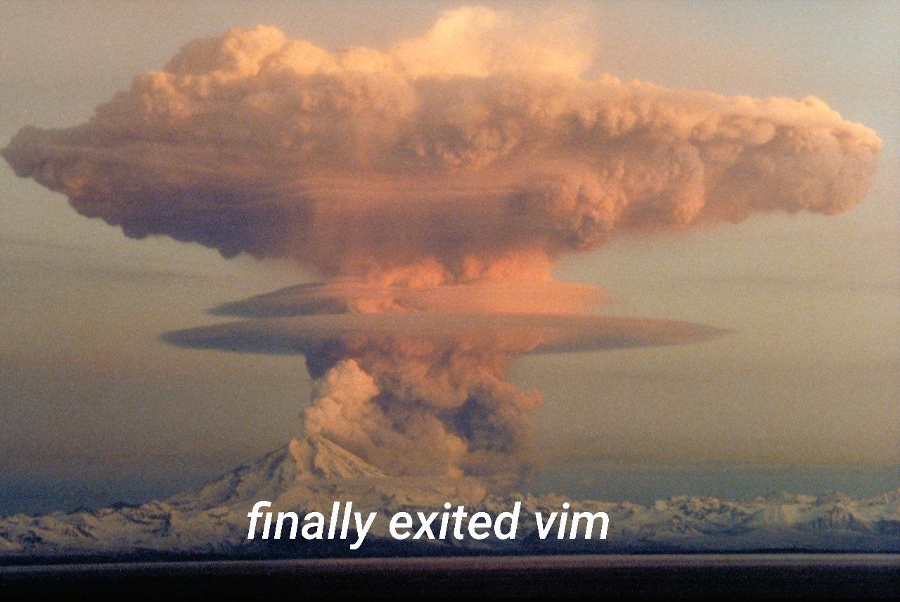 Извержение вулкана с облаком пепла и подписью «finally exited vim»