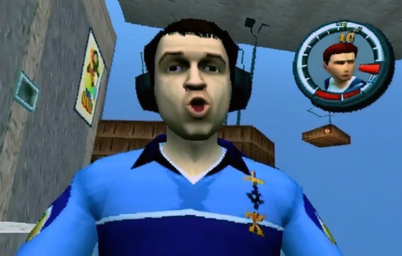 Парень в наушниках из Bully Кадр из игры «Bully» с мужчиной, который удивленно смотрит в камеру в синей одежде, а также висящий значок «40» и миниатюра игрового персонажа