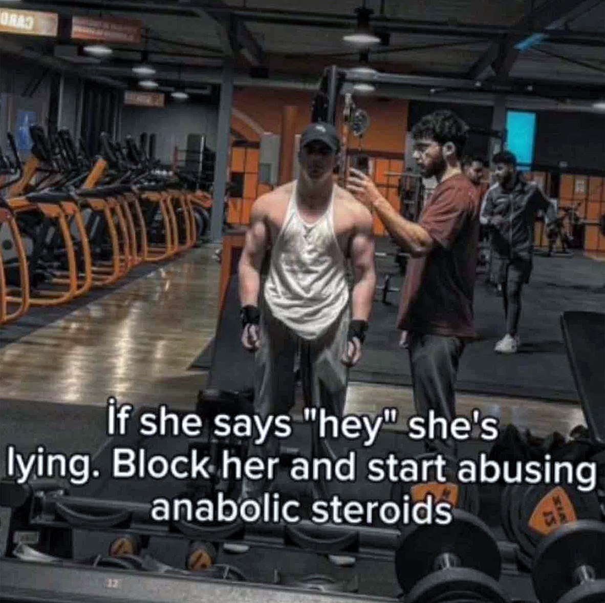 If she says "hey" she's lying Мужчина в спортзале с текстом If she says "hey" she's lying. Block her and start abusing anabolic steroids