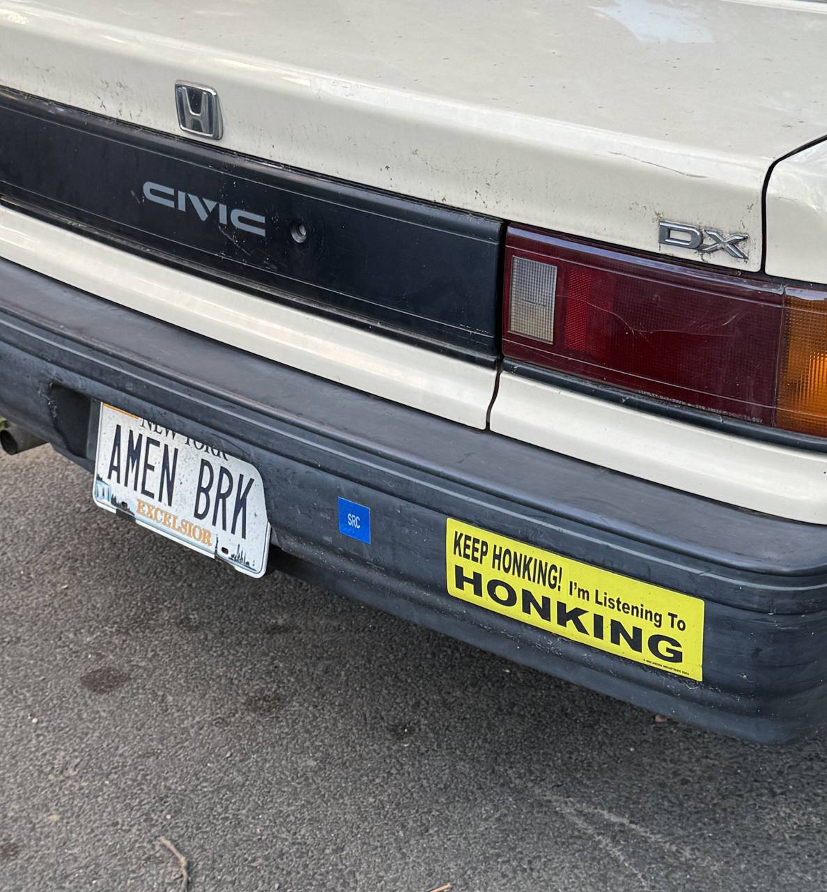 Задняя часть старого Honda Civic с забавной наклейкой «Keep honking! I'm listening to honking» («Продолжайте сигналить! Я слушаю сигнал»).