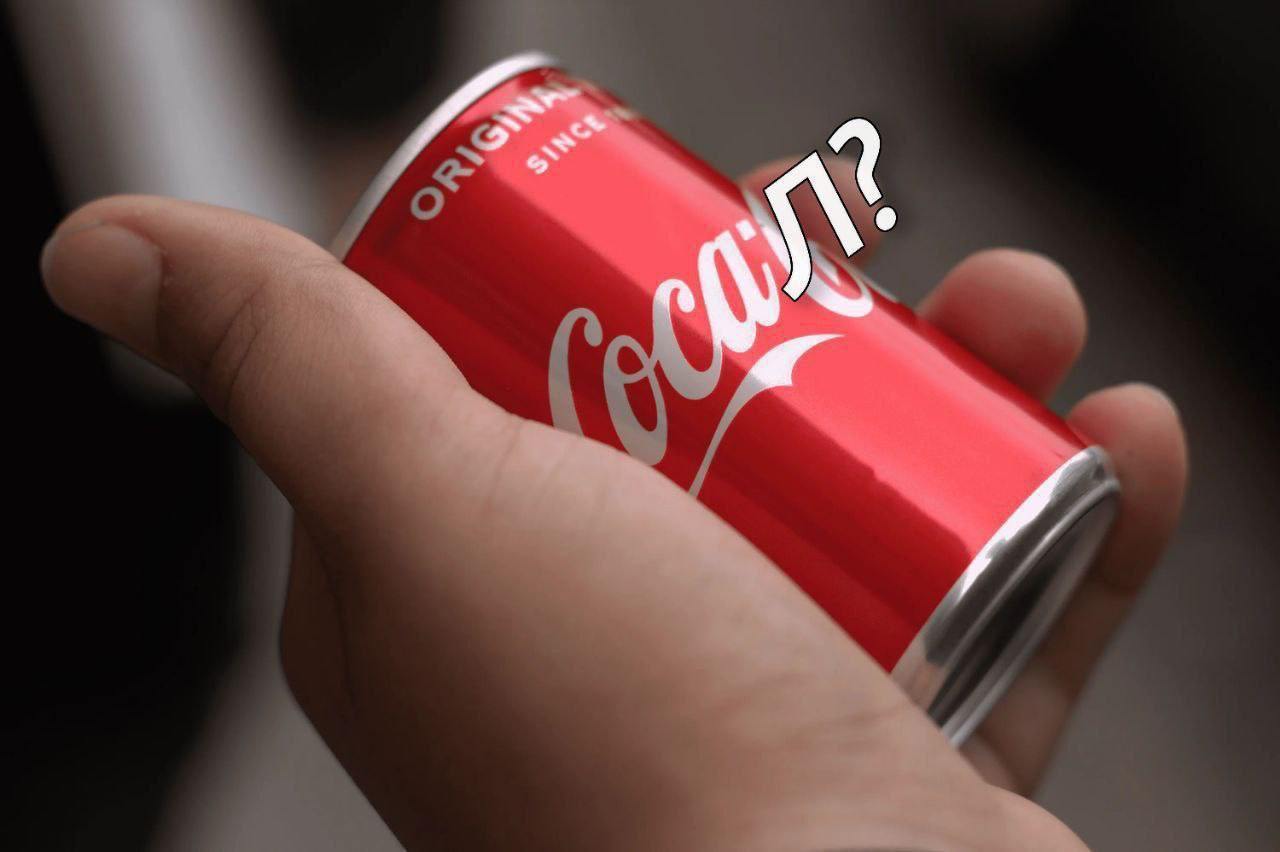Л? на банке Кока-Колы Человек держит банку Coca-Cola с надписью "Л?"