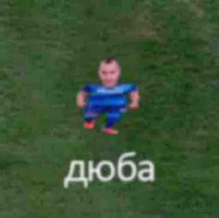 Маленький Дзюба Маленький футболист Дзюба стоит посреди футбольного поля. Он выглядит как 3D-модель из видеоигры.