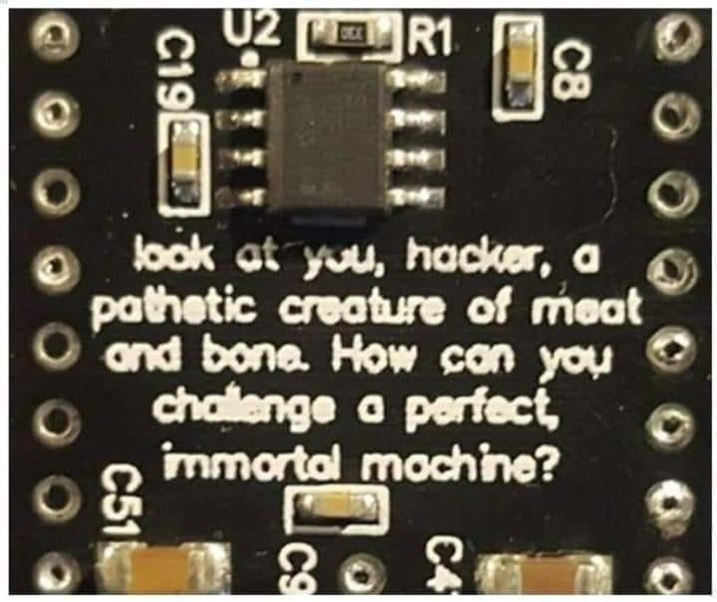 Плата с надписью «look at you, hacker, a pathetic creature of meat and bone. How can you challenge a perfect, immortal machine?»