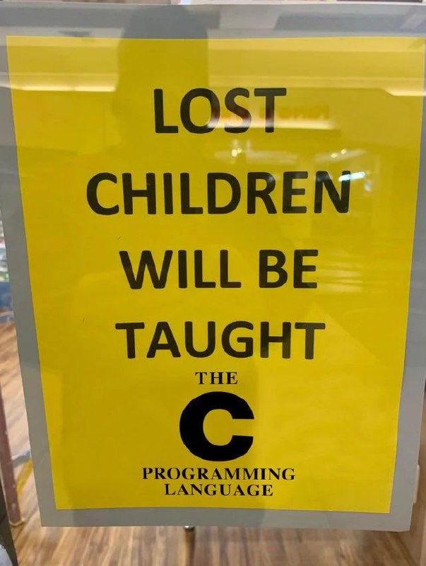 Lost children will be taught the C programming language Знак с надписью "Потерянным детям будут преподавать язык программирования C"