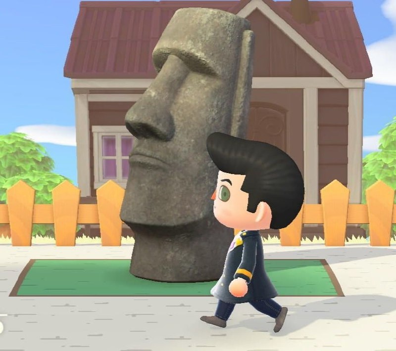 Моаи в Animal Crossing Персонаж из Animal Crossing идет мимо статуи Моаи