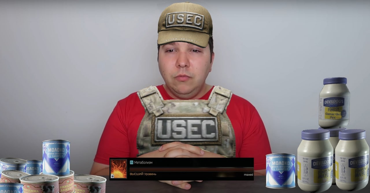 Никадо Авокадо USEC метаболизм Мужчина в кепке и бронежилете USEC, сидящий за столом, на котором стоят банки со сгущенкой и майонезом, с надписью "Метаболизм" на экране