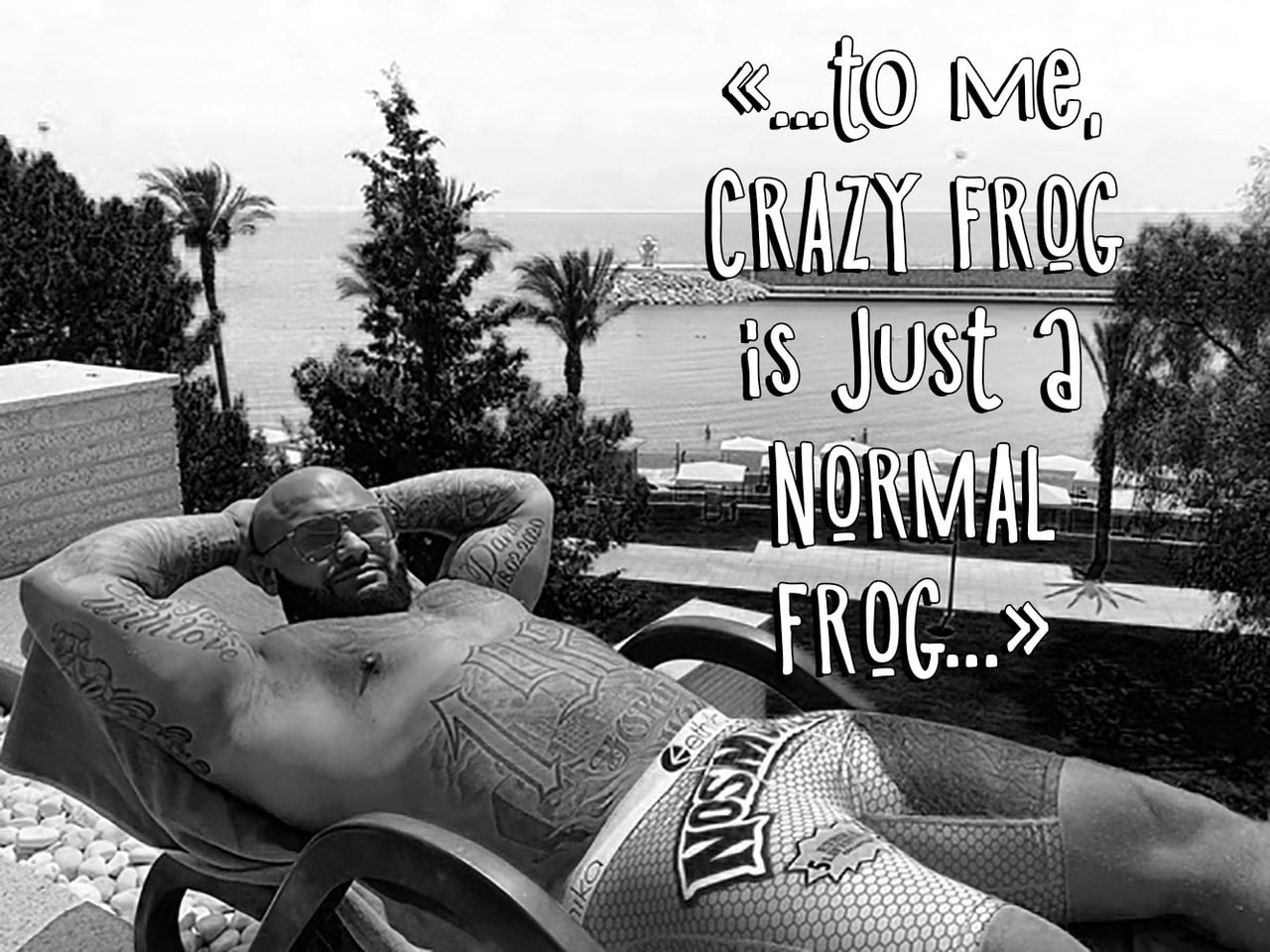 To me, Crazy Frog is just a normal frog Брутальный лысый мужчина в очках и с татуировками лежит на шезлонге на фоне моря и пальм, а рядом надпись "To me, Crazy Frog is just a normal frog..."