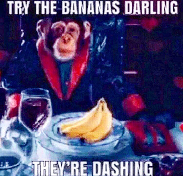 Try the bananas darling they're dashing Обезьяна в красной накидке предлагает бананы со словами «Try the bananas darling they're dashing»