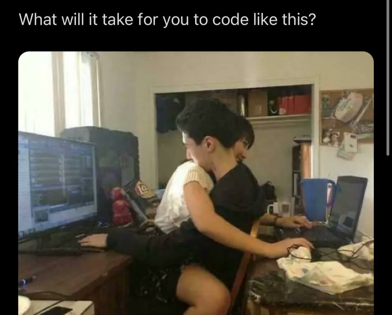Что нужно, чтобы ты так кодил? Два человека обнимаются, пока один кодит, а другой сидит у него на коленях, с подписью «What will it take for you to code like this?»